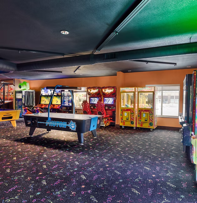 Arcade game room with air hockey table and redemption games