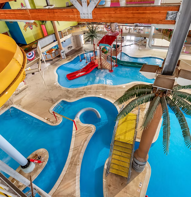 Aerial view of the winding lazy river with a yellow water slide