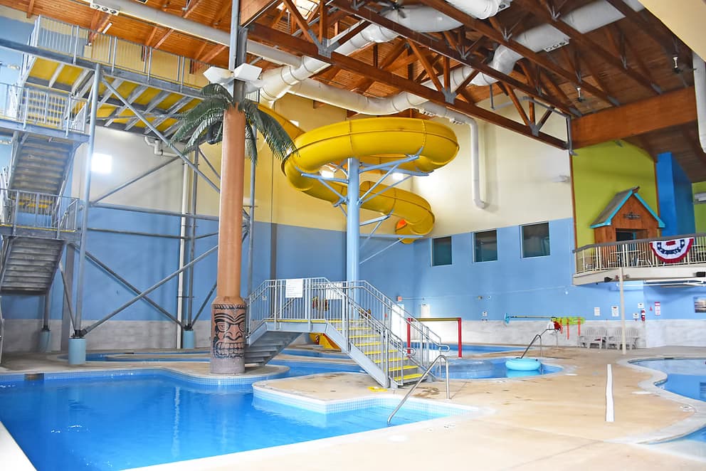 Yellow spiral water slide tower next to the hot tub area